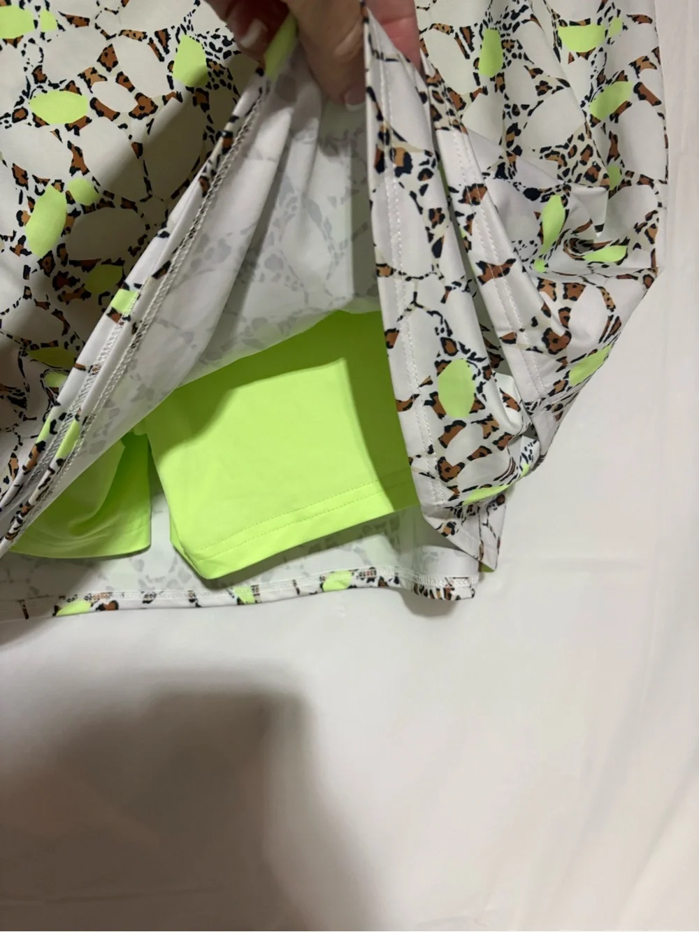 Cross court Floral Cutout Tennis Skort in White with Neon Yellow Accents